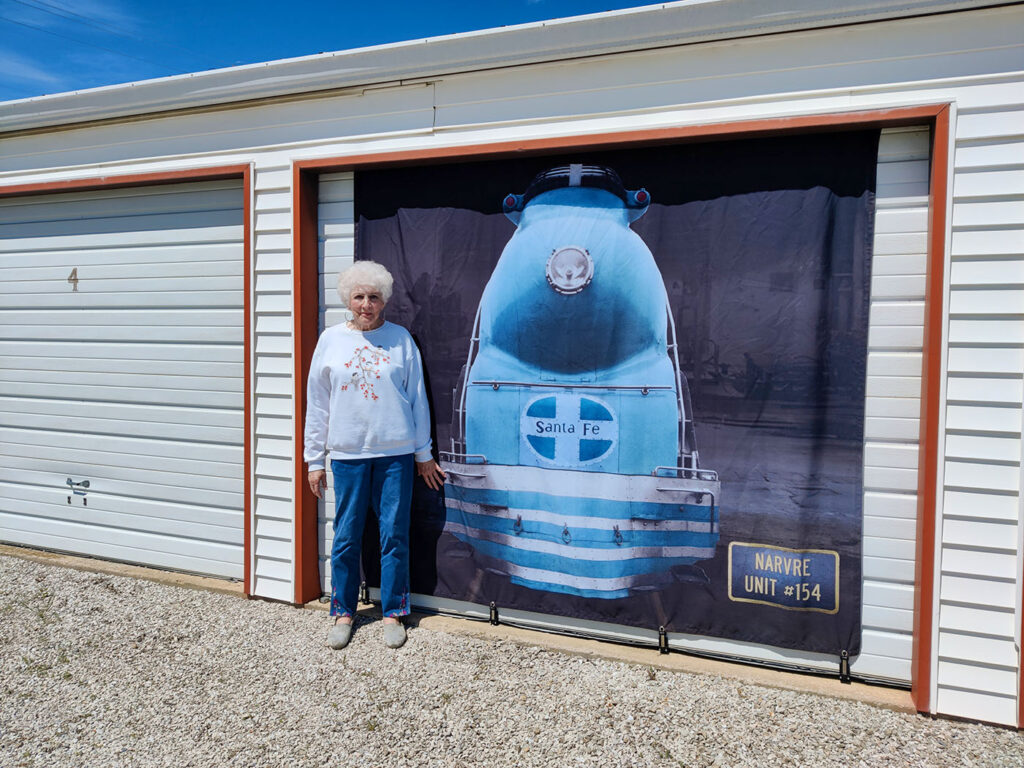 Trudy Eads with "Blue Goose" banner | Downtown Marceline